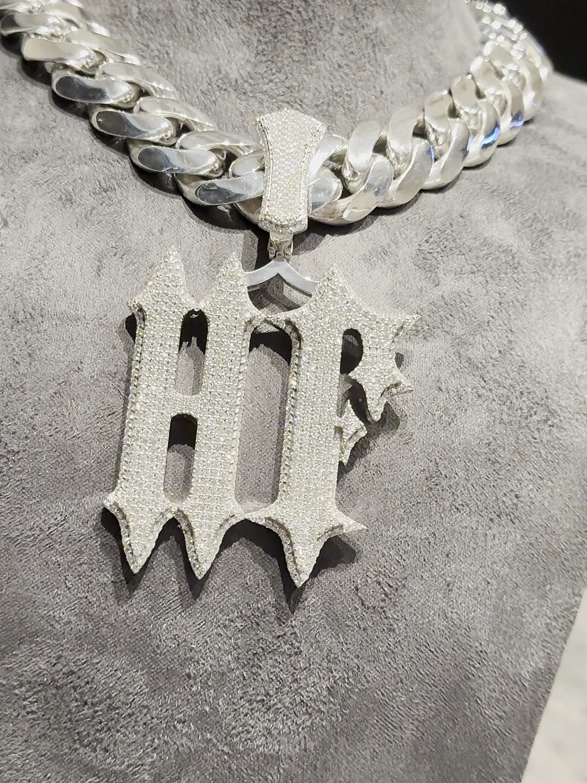 HF pendant on a Cuban chain, on the studio bust