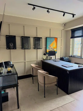The Bill Jewellers studio: panelled display wall and consultation desk